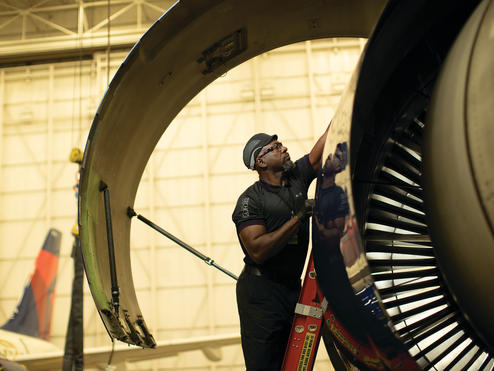 Cedric M. from Delta's TechOps team works on a Delta aircraft.