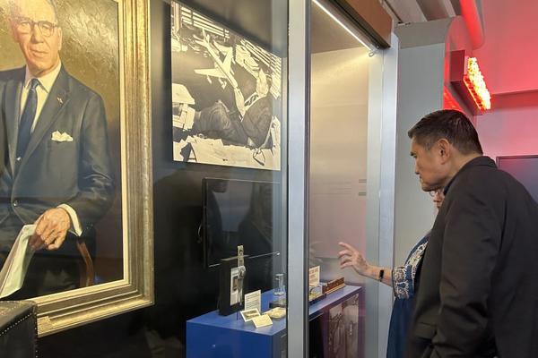 A Delta Flight Museum employee walks Todd O., Delta's most frequent flyer, through the aviation capsule collection featuring founder C.E. Woolman’s most treasured belongings. 