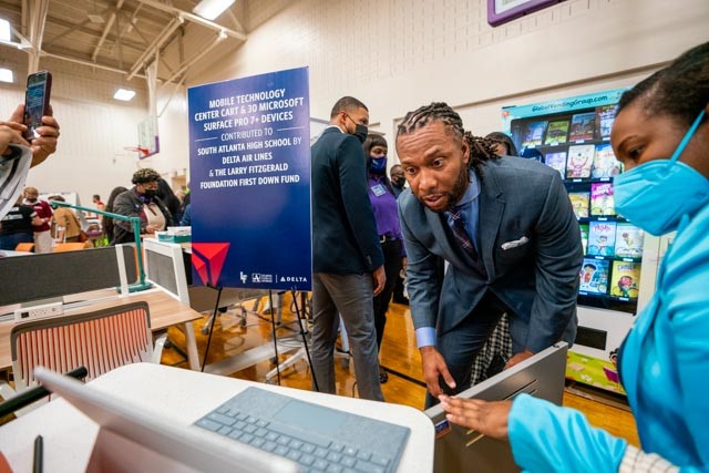 Larry Fitzgerald checks out one of the tablets presented to South Atlanta High School.