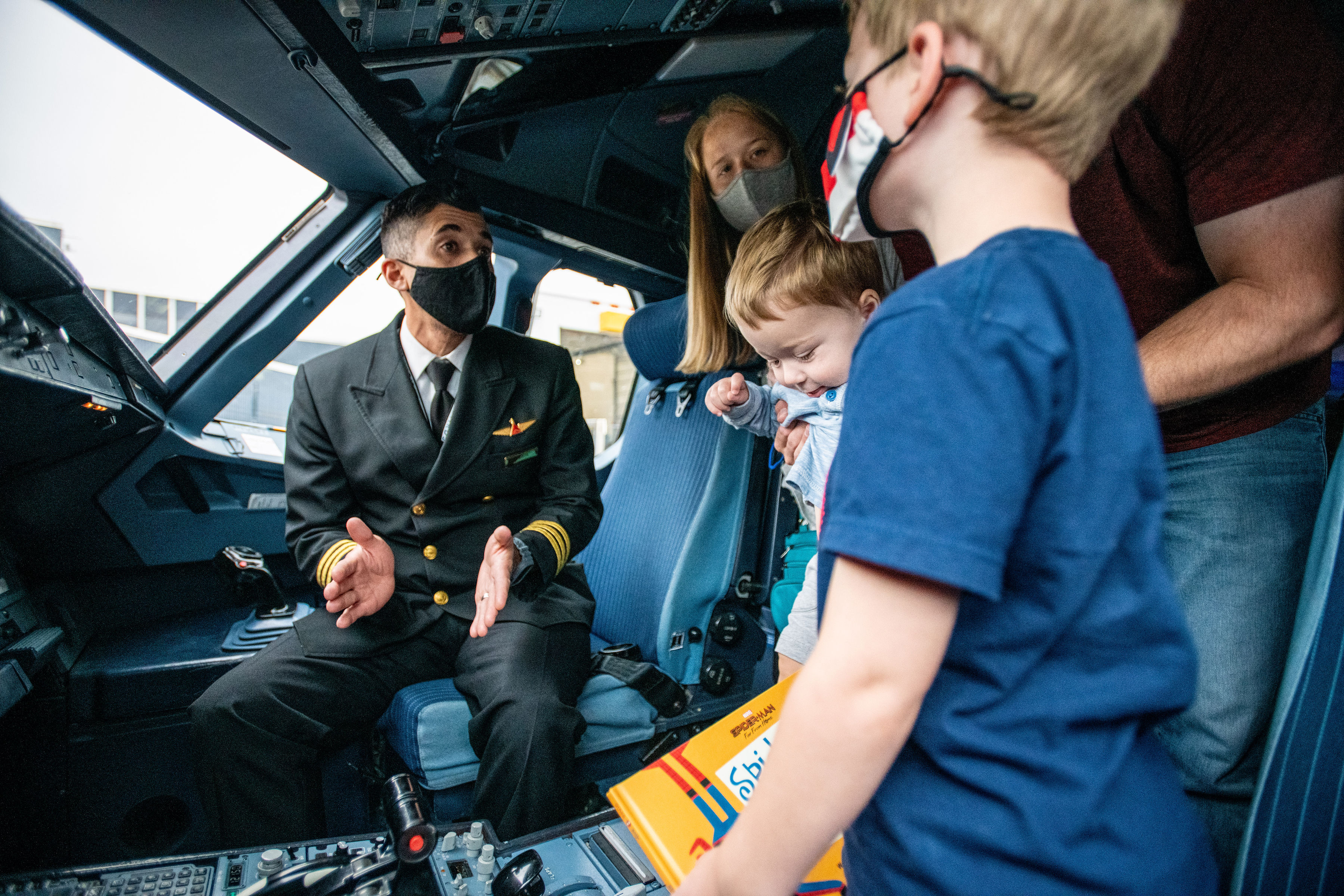 Customer and their children who participate in the Navigating MSP tour are able to explore different parts of the plane to feel comfortable with the fly process.