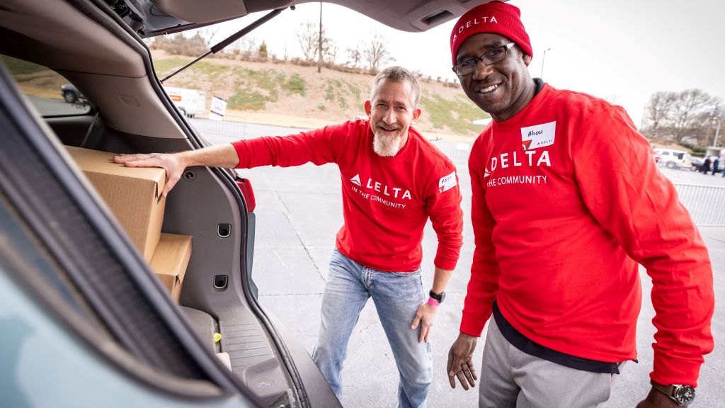 Two Delta employees volunteer at Hosea Helps in Atlanta during the annual "Hosea Helps Festival of Services" event.