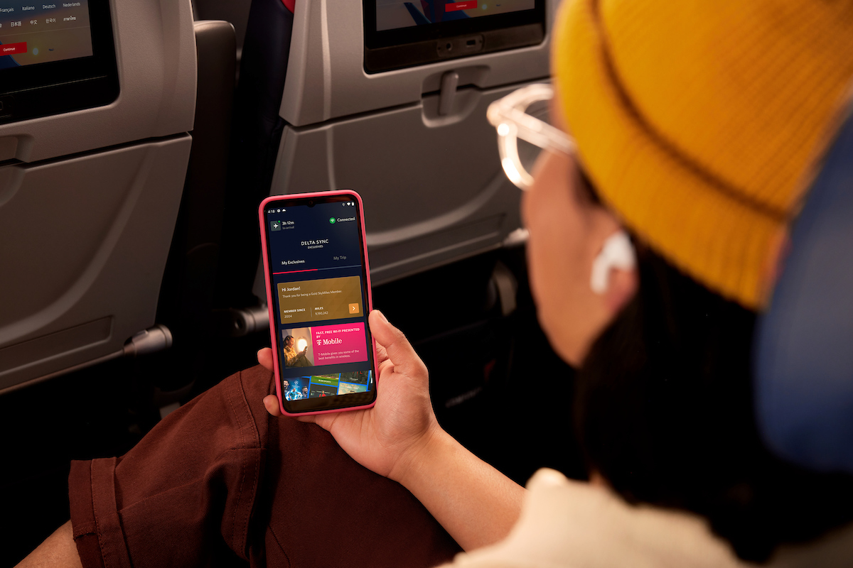 Delta customer browses the Delta Sync Exclusives using Delta's free Wi-Fi.