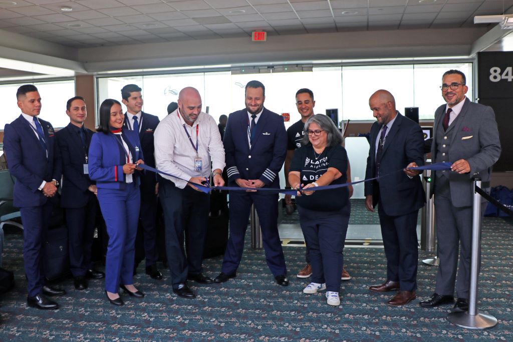 Delta and LATAM people cut a ribbon to signify the start of Bogota-Orlando service.
