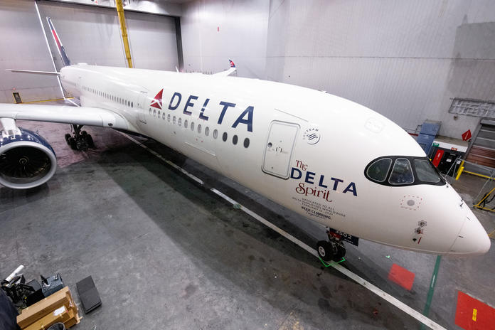 Delta Spirit A350 aircraft chocked inside a maintenance hangar.