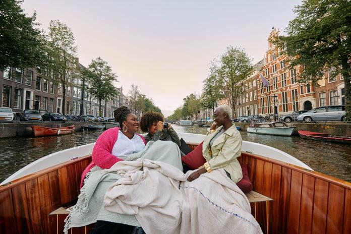 Three women sitting in a boat.