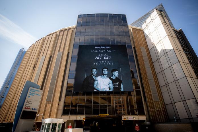 A screen advertising the Jonas Brothers' concert, available on Delta Studio in October 2022, is shown outside Madison Square Garden.