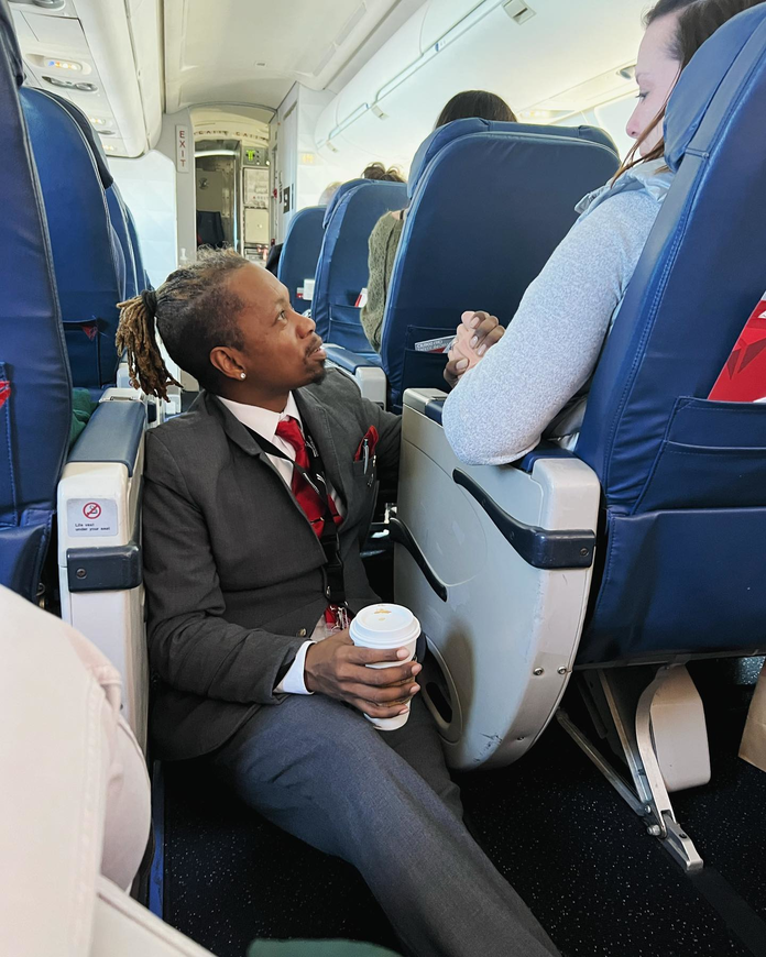 Endeavor Air flight attendant Floyd Dean-Shannon comforts a nervous customer during a Delta Connection flight from Charlotte to New York.