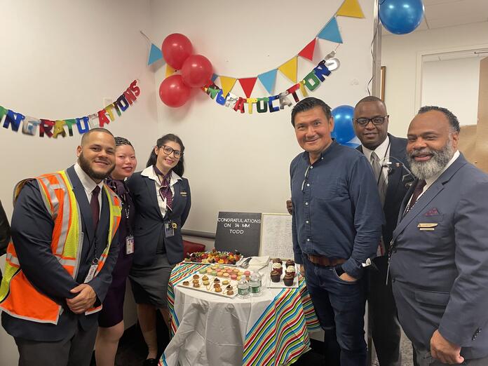 Todd O. celebrates achieving 14 Million Miler Status with Delta people at John F. Kennedy International Airport (JFK).