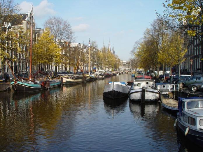 Boats and houses line one of Amsterdam's many canals.