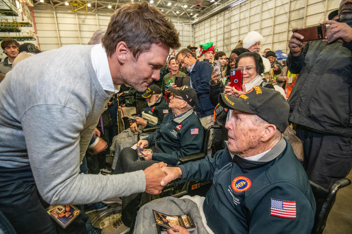 Tom Brady, a seven-time Super Bowl champion, shakes hands with a U.S. military veteran at Delta's 12th annual Veterans Celebration.