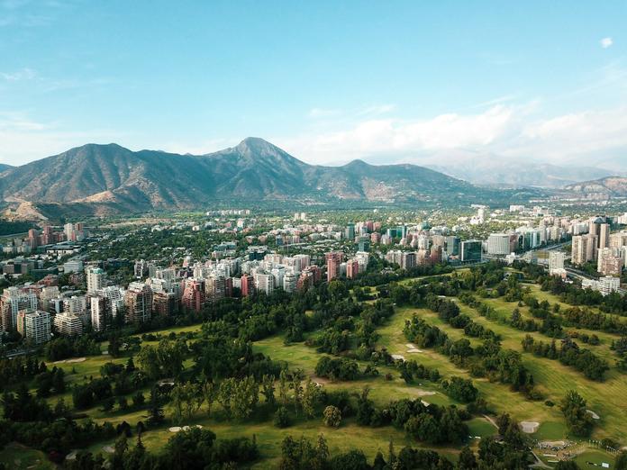 A scenic view of Santiago, Chile with mountains behind a city