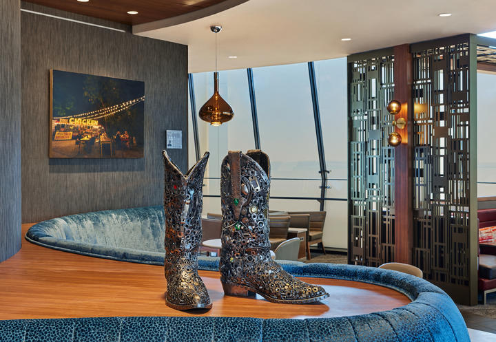 A pewter rhinestone cowboy boot sculpture sits in the Delta Sky Club in Austin, Texas.