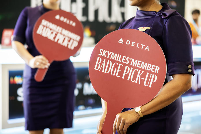 Austin-based flight attendants and Red Coats assist in assisting guests with a dedicated badge pick-up area for SkyMiles Members at the Austin Convention Center Rotunda Foyer during SXSW 2024.