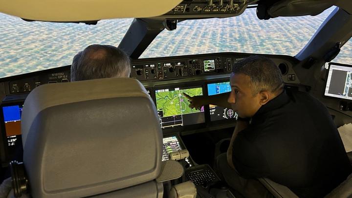 Capt. Daniels runs through a calculation with Capt. Marshall during their flight simulation on April 5.