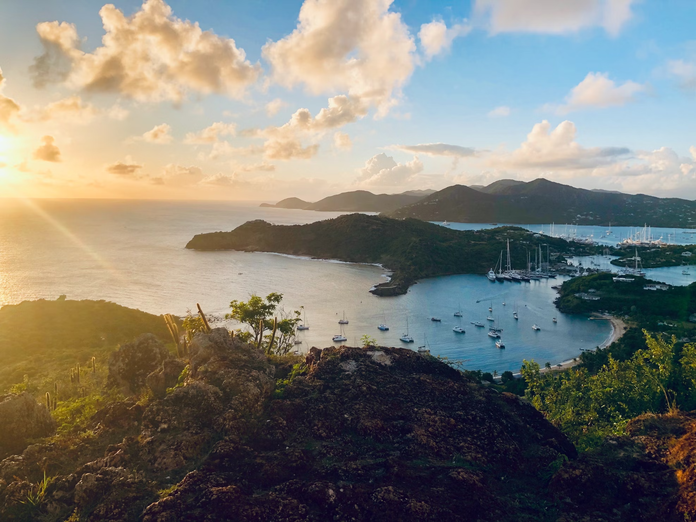 A bay filled with boats during sunset in the Caribbean island of Antigua and Barbuda
