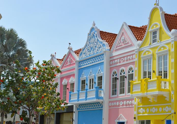 A row of brightly colored houses on a street in Oranjestad, Aruba.