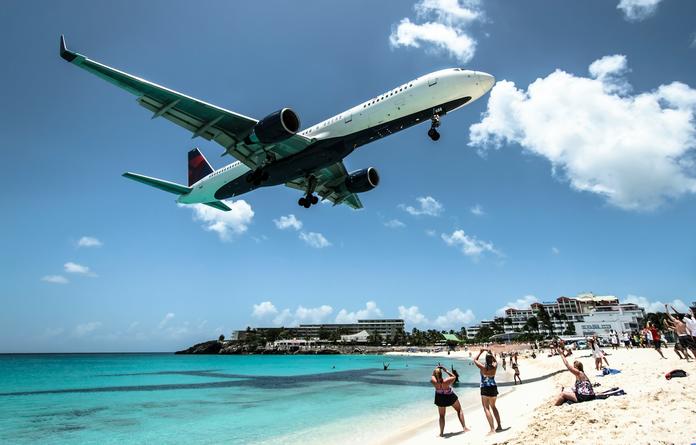 A Delta plane flies over Maho Beach in St. Maarten.