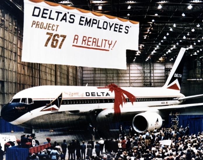 The Spirit of Delta plane sits below a large "Project 767" banner.