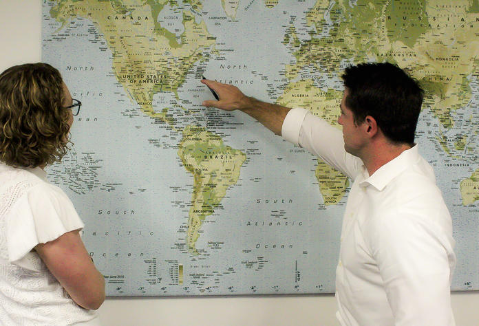 David Hart, Managing Director - Domestic Network Planning, confers with a colleague while pointing at a map.