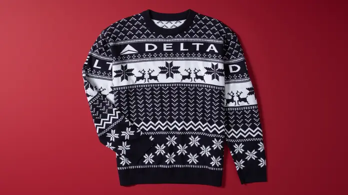 Show off your love for travel this winter with our Navy Delta Holiday Sweater. Cozy and colorful, this sweater is perfect for any festive occasion. 