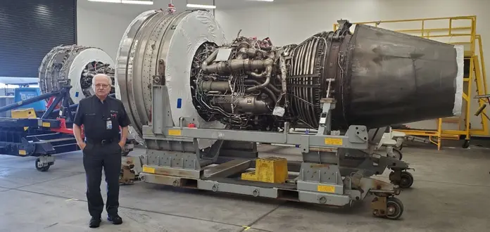 Jimmy posing in front of aircraft engine