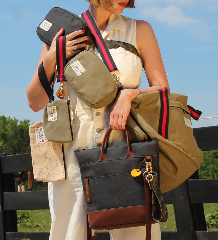 Person holding six different styles of handbags