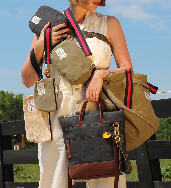 Person holding six different styles of handbags