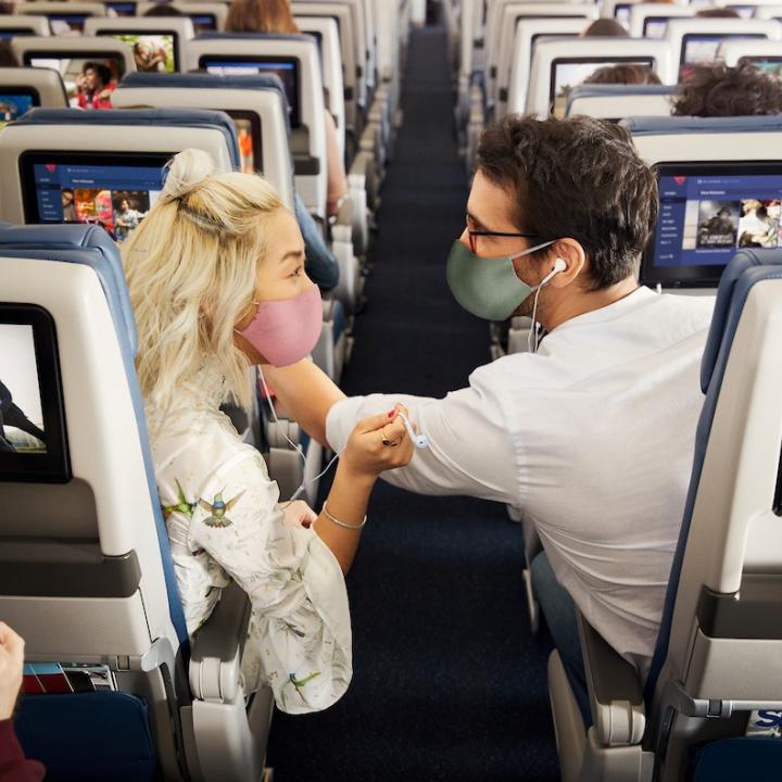 Passengers enjoying in-flight entertainment.