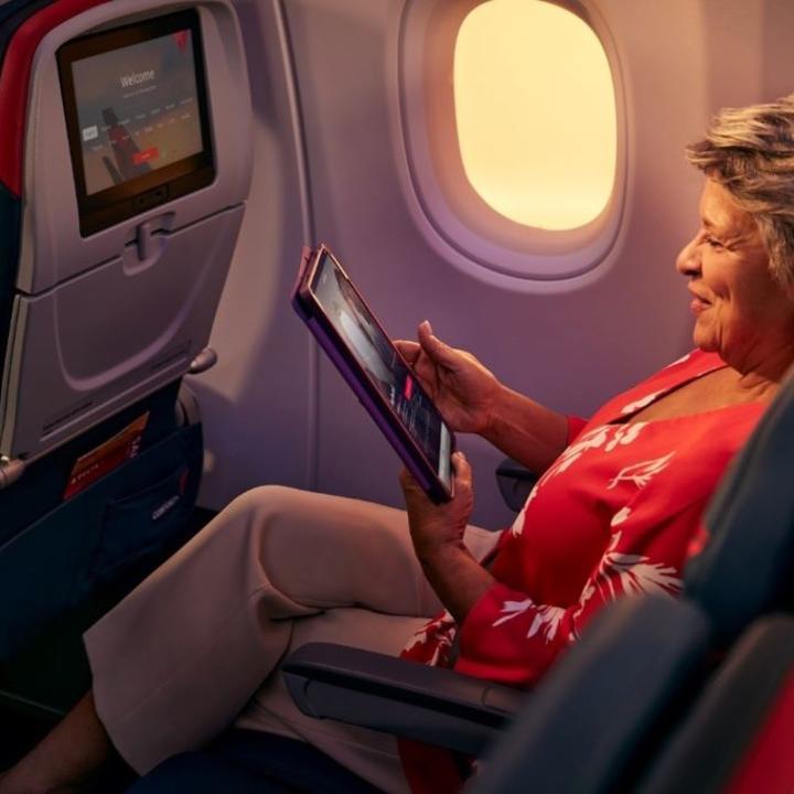 Delta customer using their tablet onboard.