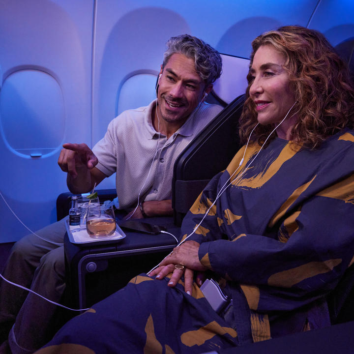 Delta customers sitting in First Class enjoy seatback entertainment.