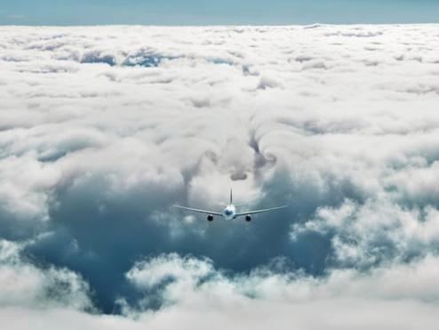 Plane flying through clouds.