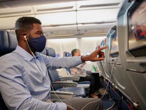 Customer on aircraft with mask, IFE