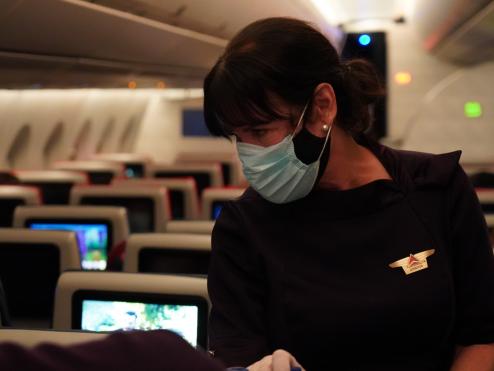 Delta Air Lines Flight Attendant serves passengers during CRAF mission.