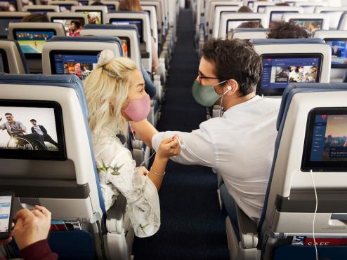 Passengers enjoying in-flight entertainment.