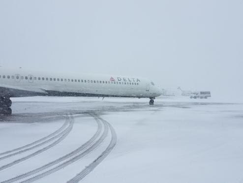Parked Delta plane in snow.