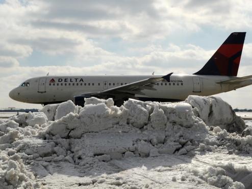 A319 moving safely past a mound of snow