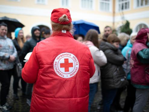 A Red Cross worker helps people in Ukraine.