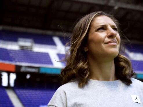 Close up of soccer legend Carli Lloyd standing in a soccer stadium
