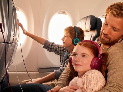 Delta customers enjoying in-flight entertainment