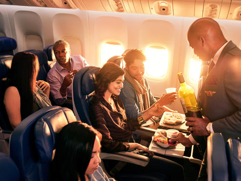 Delta Flight Attendant Robert F. serves customers on board.