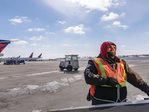 A Delta Aircraft Load Agent works in winter conditions at Minneapolis-St. Paul International Airport (MSP).