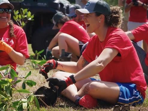 Delta employees participate in a tree planting in 2022.