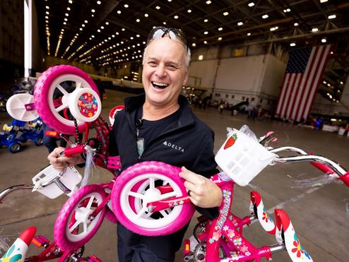 Delta people from TechOps, In-Flight Service, Global Sales, Finance, IT and Flight Operations rallied to purchase and assemble bicycles, as well as rally toy and money donations to support Toys for Tots.