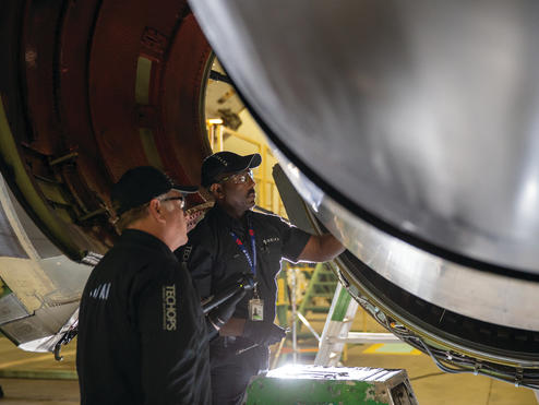 Two Delta TechOps employees are shown working in this 2020 photo.