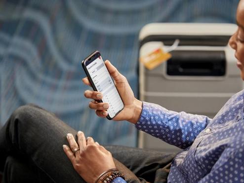 A Delta customer uses the Fly Delta app to view their flight.