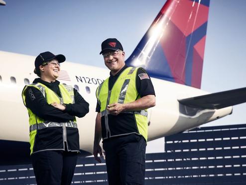 Delta TechOps employees standing in front of an aircraft
