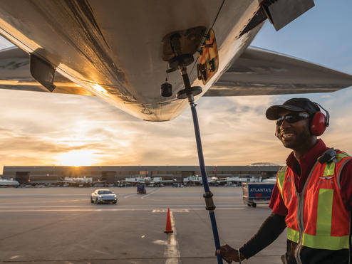 Ramp agent working under an aircraft