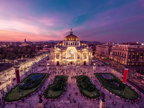 The Palacio de Bellas Artes in Mexico City gleams at twilight.