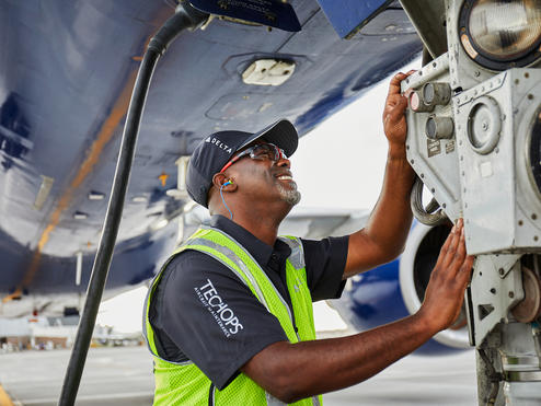 A Delta TechOps employee works on an aircraft