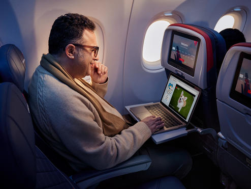 A customer enjoys surfing the web using Delta's fast, free Wi-Fi powered by T-Mobile.